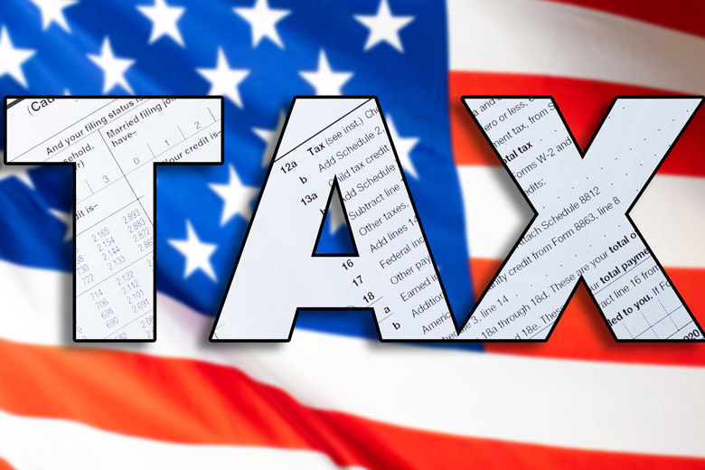 The word "TAX" in large bold letters, filled with images of tax forms, is overlaid on a blurred American flag background. The word "TAX" in large bold letters, filled with images of tax forms, is overlaid on a blurred American flag background.