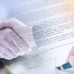A close-up of a person signing a document with a pen, overlaid with two people shaking hands—symbolizing agreement and partnership—reflects the importance of following a Year-End Tax Checklist for California Taxpayers and Business Owners.
