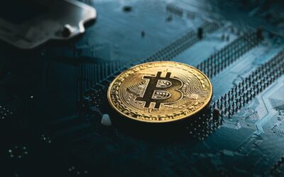 A gold Bitcoin coin rests on a dark computer circuit board, symbolizing cryptocurrency, digital finance technology, and the future of Crypto Tax Reporting 2026.