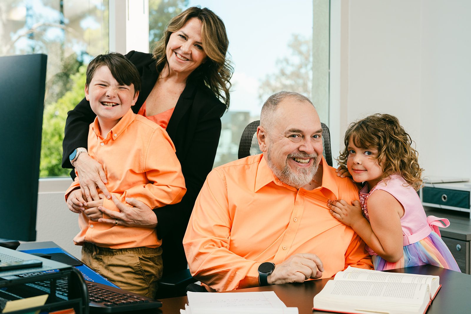 Pietro Canestrelli with his wife Kristen and their grandchildren at his desk in the Law Office of Pietro Canestrelli.