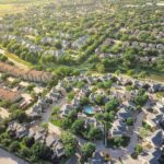 Investor reviewing Opportunity Zone fund documents and deferred gain deadline with a tax attorney